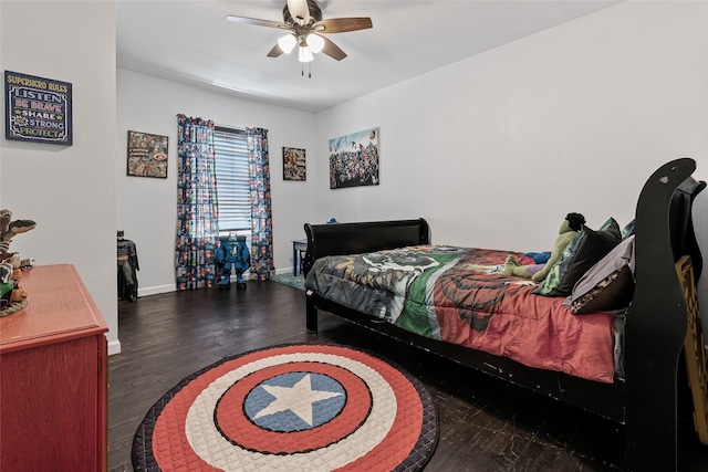 bedroom featuring a ceiling fan, wood finished floors, and baseboards