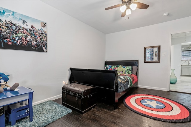 bedroom featuring attic access, wood finished floors, and baseboards