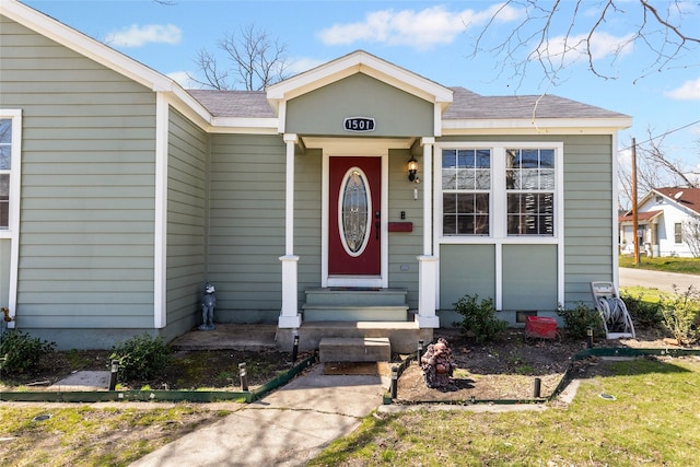 entrance to property with roof with shingles