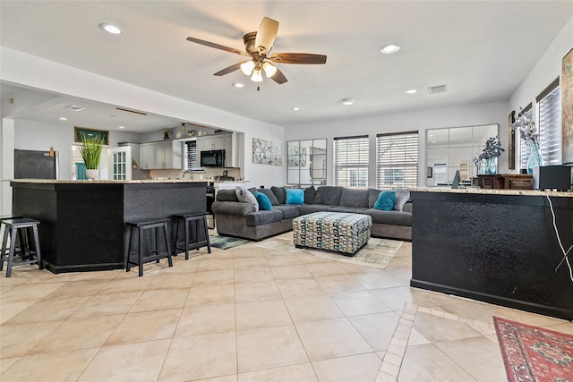 living area with light tile patterned floors, recessed lighting, a ceiling fan, and a healthy amount of sunlight