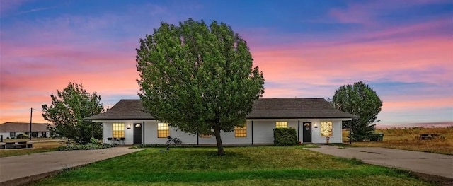 view of front of property with driveway and a front lawn