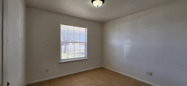 spare room featuring baseboards