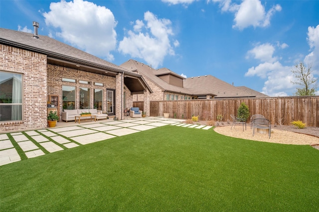 view of yard with an outdoor living space with a fire pit, a patio, and a fenced backyard