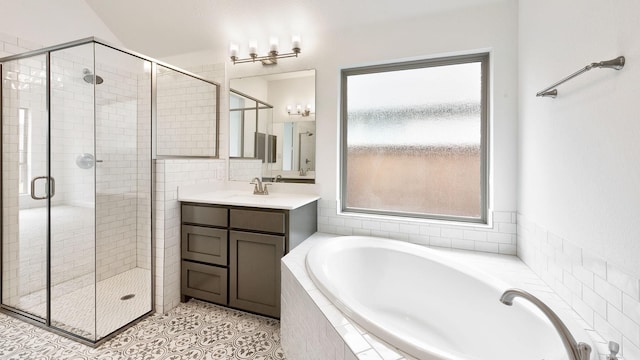 full bath with a healthy amount of sunlight, a stall shower, and a garden tub