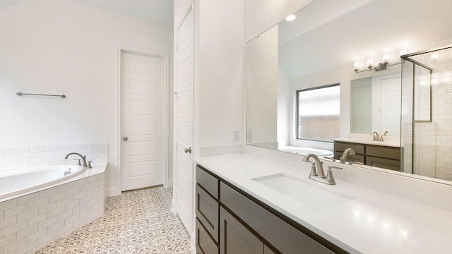 bathroom with tiled shower, a garden tub, vanity, and tile patterned flooring