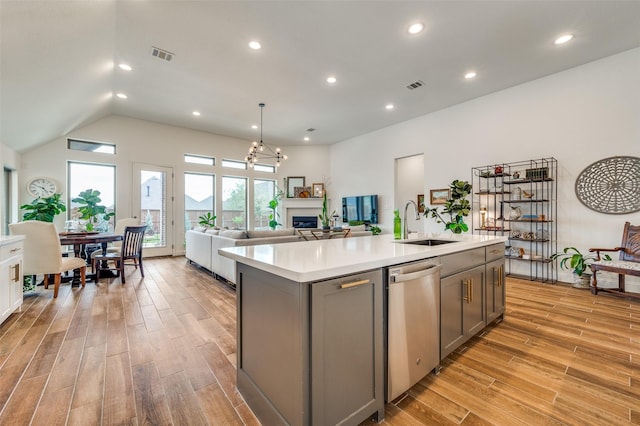 kitchen with visible vents, gray cabinets, dishwasher, and a sink