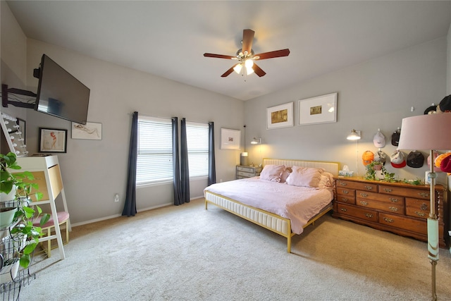 carpeted bedroom featuring vaulted ceiling, a ceiling fan, and baseboards