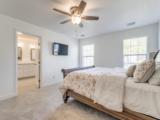 206 Cocopa Dr, Lake Kiowa, TX 76240 - bedroom with baseboards, light colored carpet, ensuite bath, and ceiling fan