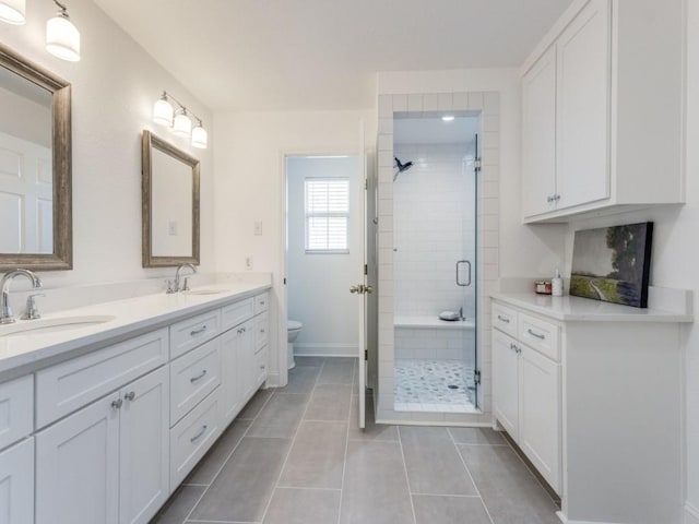 206 Cocopa Dr, Lake Kiowa, TX 76240 - bathroom featuring a shower stall, double vanity, toilet, tile patterned floors, and baseboards