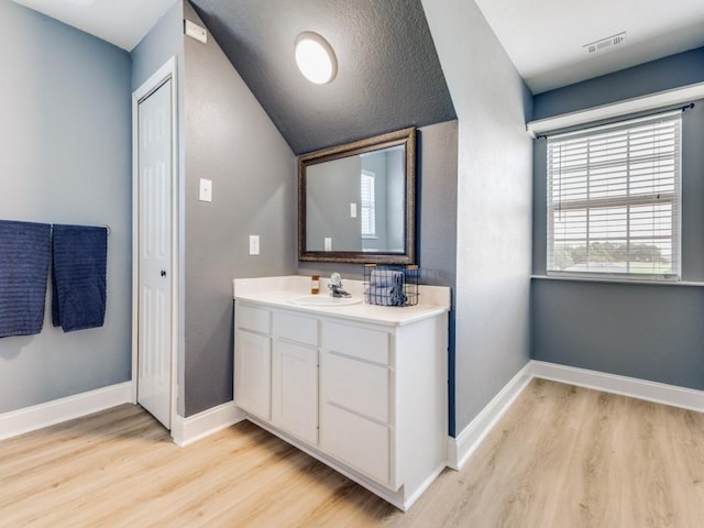206 Cocopa Dr, Lake Kiowa, TX 76240 - bathroom featuring wood finished floors, vanity, baseboards, and lofted ceiling