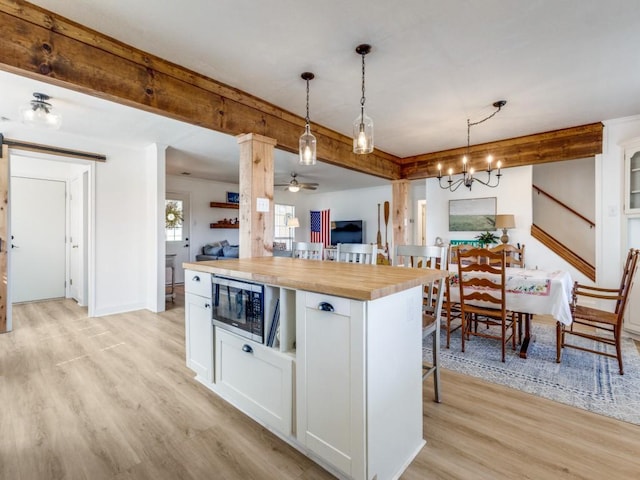 206 Cocopa Dr, Lake Kiowa, TX 76240 - kitchen with wood counters, built in microwave, white cabinets, and light wood finished floors