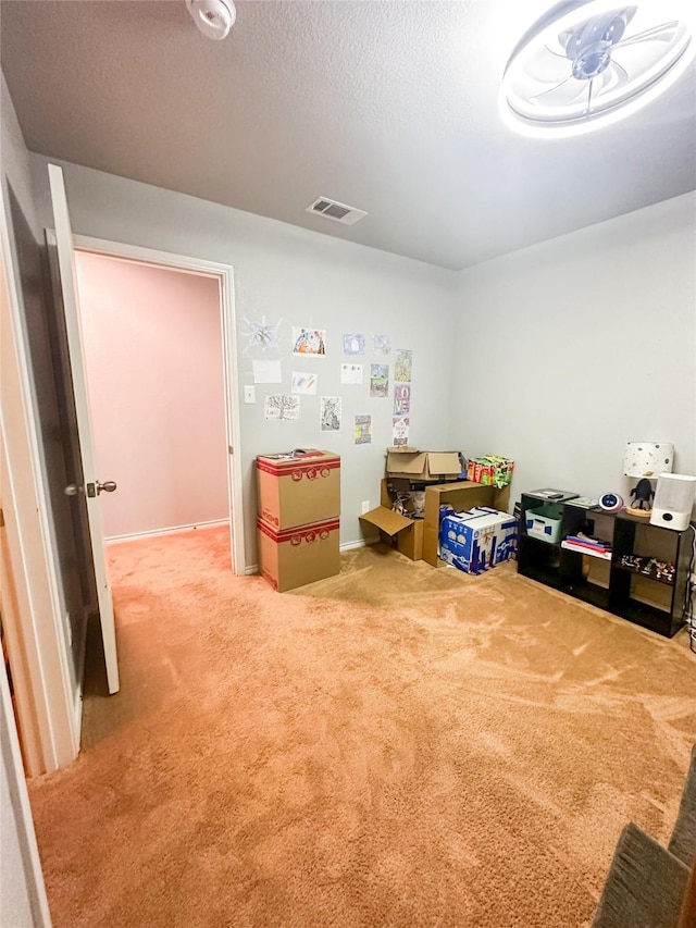 rec room featuring carpet, visible vents, and a textured ceiling