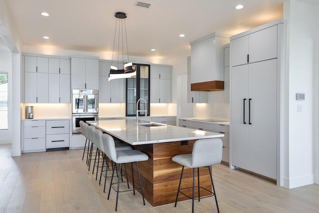 1733 E Lake Dr, Weatherford, TX 76087 - kitchen featuring light wood-style flooring, double oven, modern cabinets, and a sink