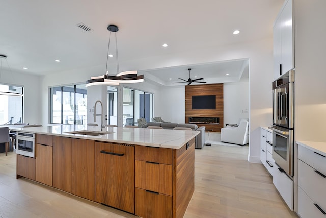 1733 E Lake Dr, Weatherford, TX 76087 - kitchen with visible vents, modern cabinets, ceiling fan, and a sink
