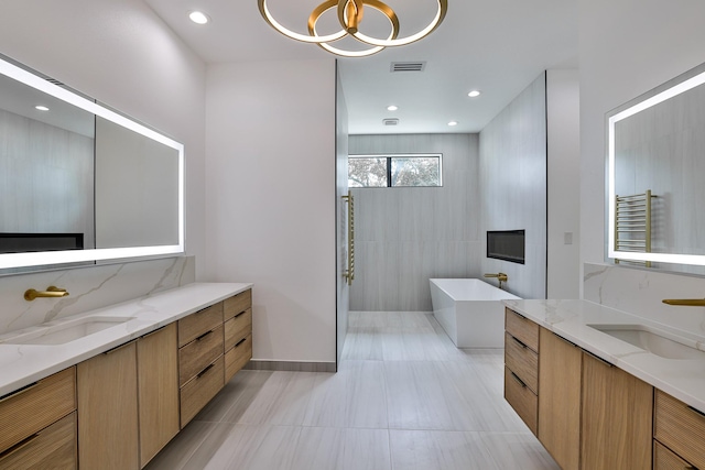 1733 E Lake Dr, Weatherford, TX 76087 - full bathroom with a soaking tub, two vanities, and a sink