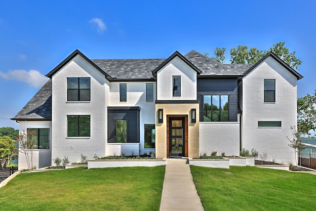 1733 E Lake Dr, Weatherford, TX 76087 - modern farmhouse featuring a front lawn and brick siding