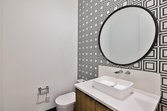 1733 E Lake Dr, Weatherford, TX 76087 - bathroom featuring vanity, toilet, and backsplash
