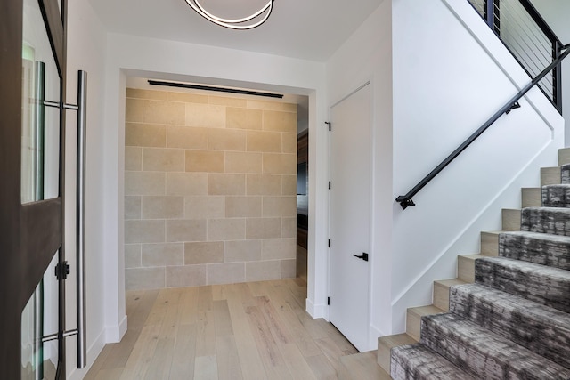 1733 E Lake Dr, Weatherford, TX 76087 - foyer entrance with stairway, tile walls, and wood finished floors