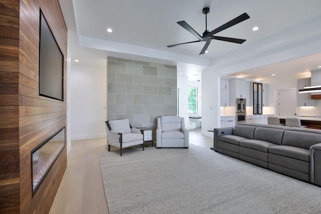 1733 E Lake Dr, Weatherford, TX 76087 - living area with a ceiling fan, recessed lighting, light wood-style floors, an accent wall, and a large fireplace