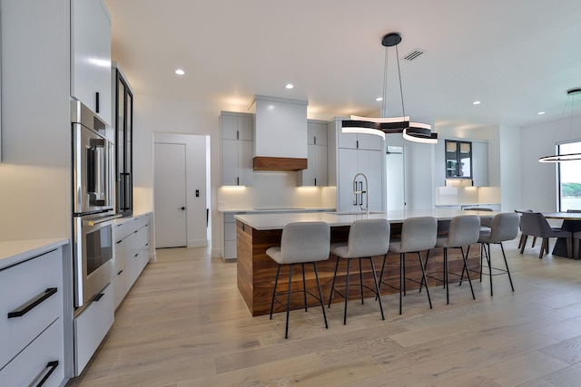 1733 E Lake Dr, Weatherford, TX 76087 - kitchen with visible vents, stainless steel oven, custom exhaust hood, modern cabinets, and a sink