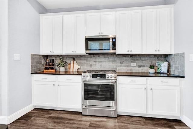 kitchen featuring appliances with stainless steel finishes, dark countertops, backsplash, and baseboards