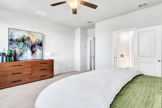 carpeted bedroom with visible vents, baseboards, and ensuite bath