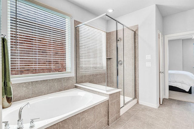 full bathroom with a bath, a stall shower, tile patterned flooring, and a wealth of natural light