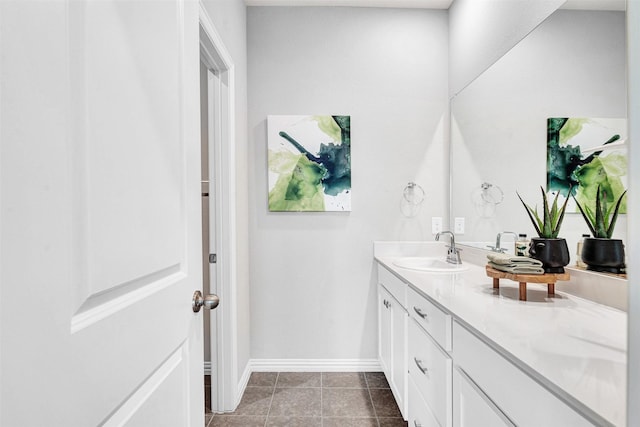 bathroom with tile patterned flooring, vanity, and baseboards