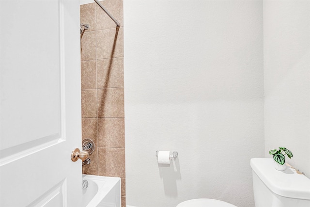 bathroom with toilet and  shower combination