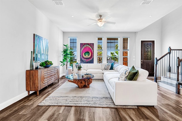 living room with visible vents, baseboards, a ceiling fan, and wood finished floors