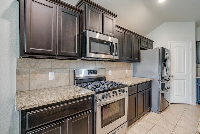 kitchen with dark brown cabinets, appliances with stainless steel finishes, light tile patterned floors, and light countertops