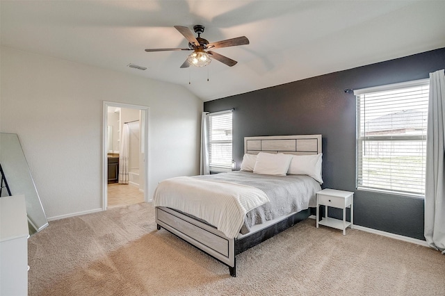 bedroom featuring baseboards, visible vents, ceiling fan, vaulted ceiling, and light carpet