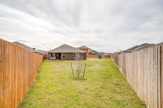 view of yard with a fenced backyard