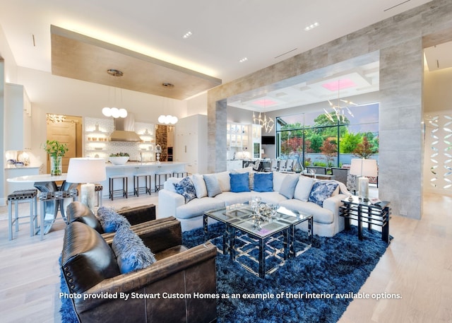 living area with a notable chandelier and wood finished floors