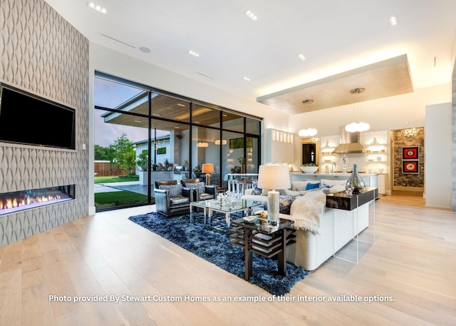 living area with a large fireplace and light wood-type flooring