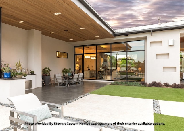 patio terrace at dusk featuring outdoor dining area