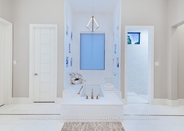 full bath featuring a garden tub and tile patterned flooring