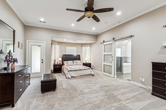 carpeted bedroom featuring a barn door, baseboards, visible vents, and ornamental molding