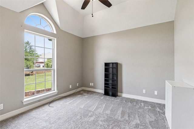 unfurnished room featuring lofted ceiling, baseboards, carpet floors, and ceiling fan