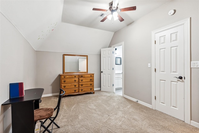 carpeted home office featuring visible vents, baseboards, lofted ceiling, and ceiling fan