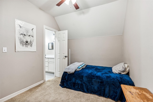 carpeted bedroom featuring connected bathroom, baseboards, ceiling fan, and vaulted ceiling