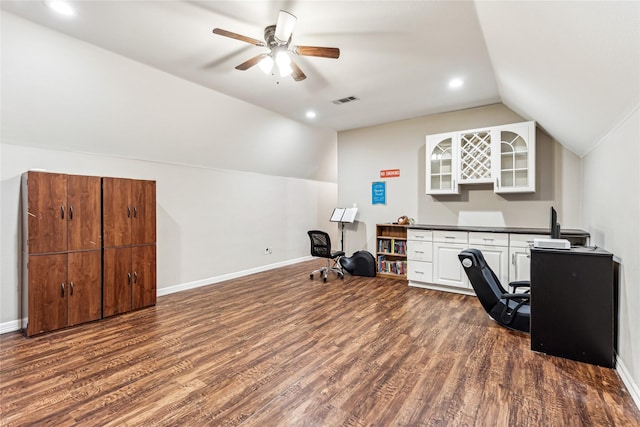 home office featuring baseboards, visible vents, lofted ceiling, ceiling fan, and dark wood-type flooring
