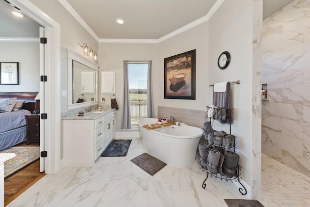 ensuite bathroom featuring vanity, a freestanding tub, ornamental molding, marble finish floor, and connected bathroom