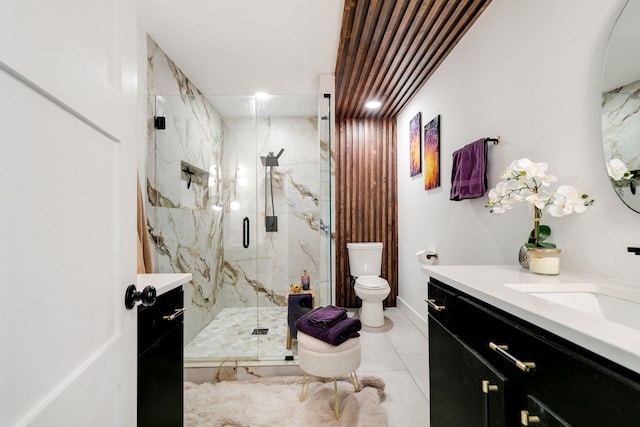 full bathroom with a marble finish shower, toilet, and vanity