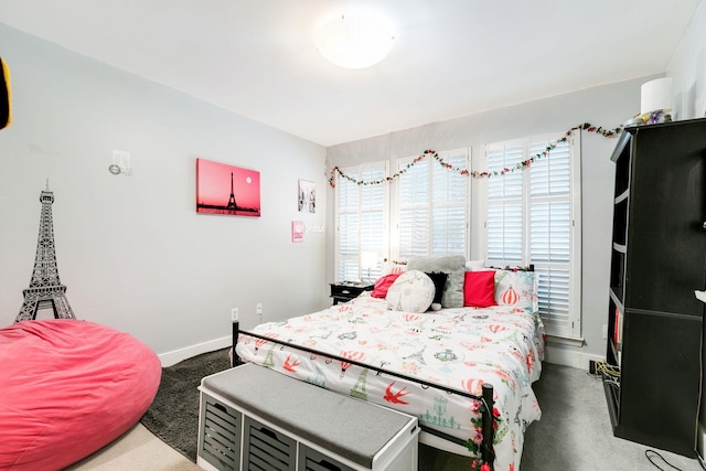 carpeted bedroom featuring baseboards