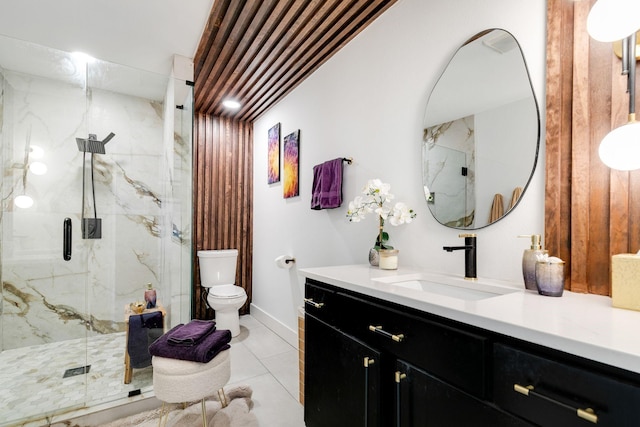 bathroom featuring tile patterned floors, a marble finish shower, toilet, and vanity
