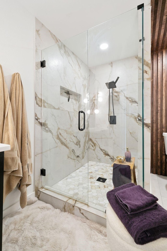 full bath with a marble finish shower