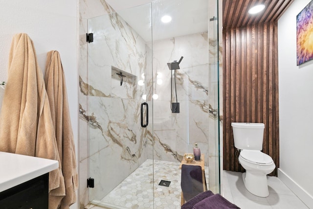 full bathroom featuring vanity, toilet, baseboards, and a marble finish shower