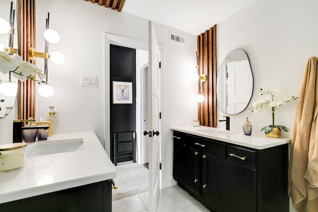 full bathroom with tile patterned flooring, two vanities, visible vents, and a sink