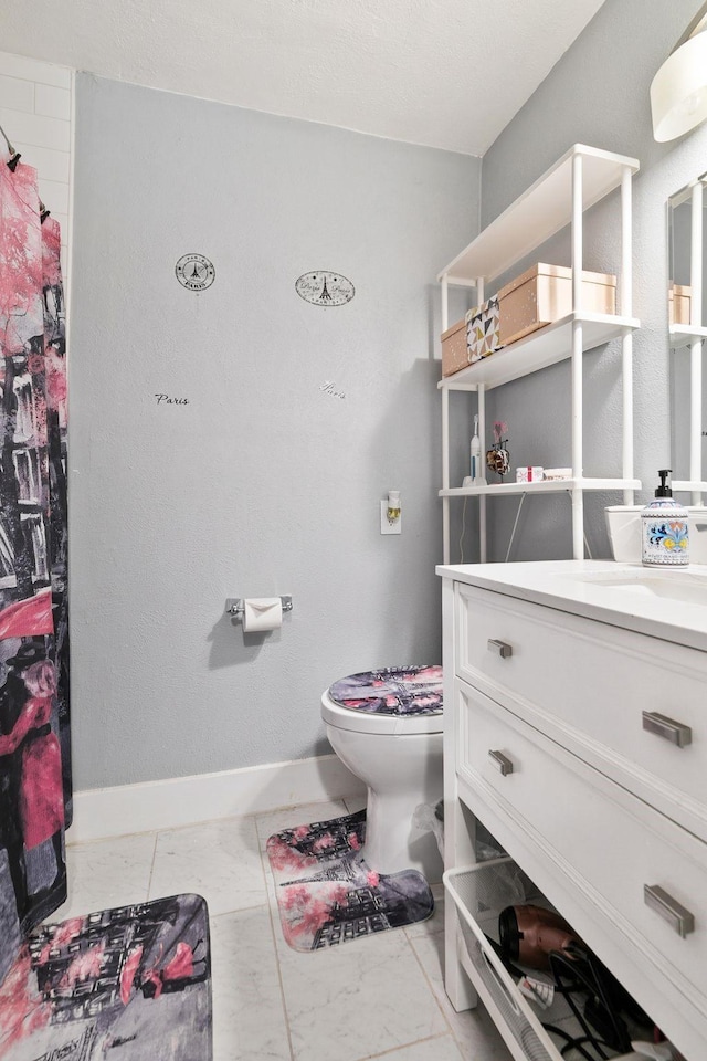 bathroom with curtained shower, baseboards, toilet, marble finish floor, and vanity